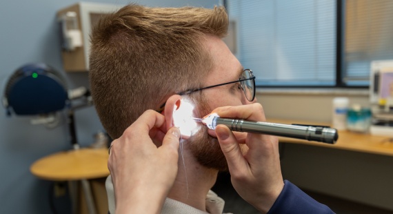 Matthew getting hearing aid fitting