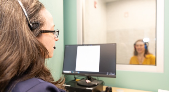 Dr. Suzanne Yoder working with patient in the hearing room
